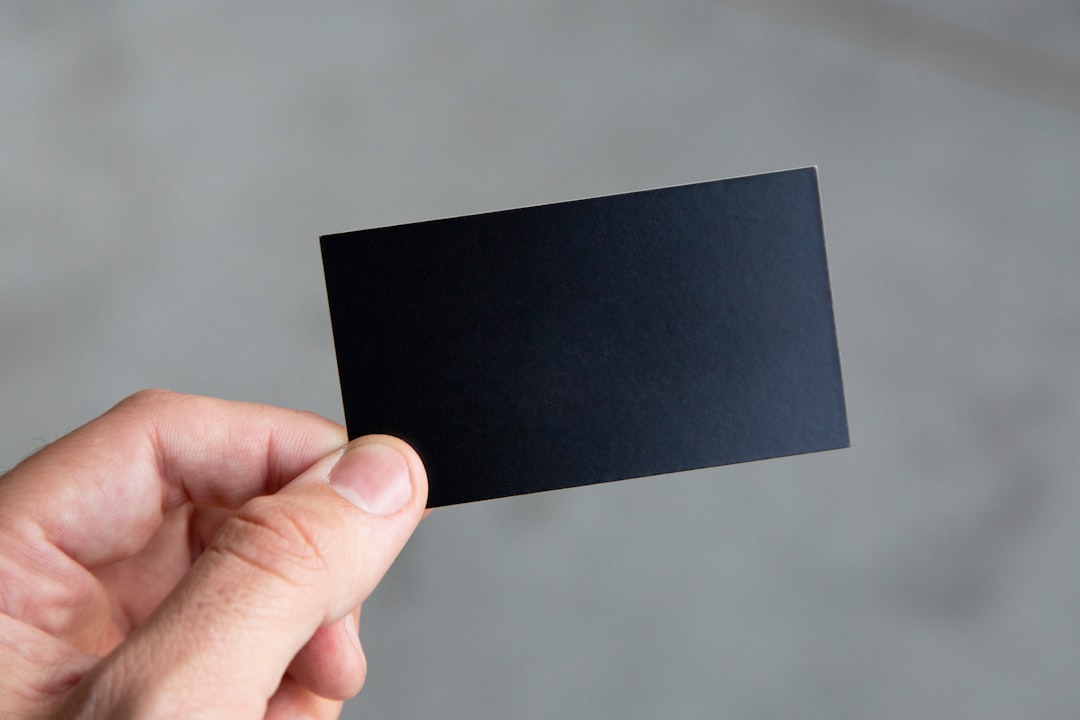 Hand holding a card-like material sample